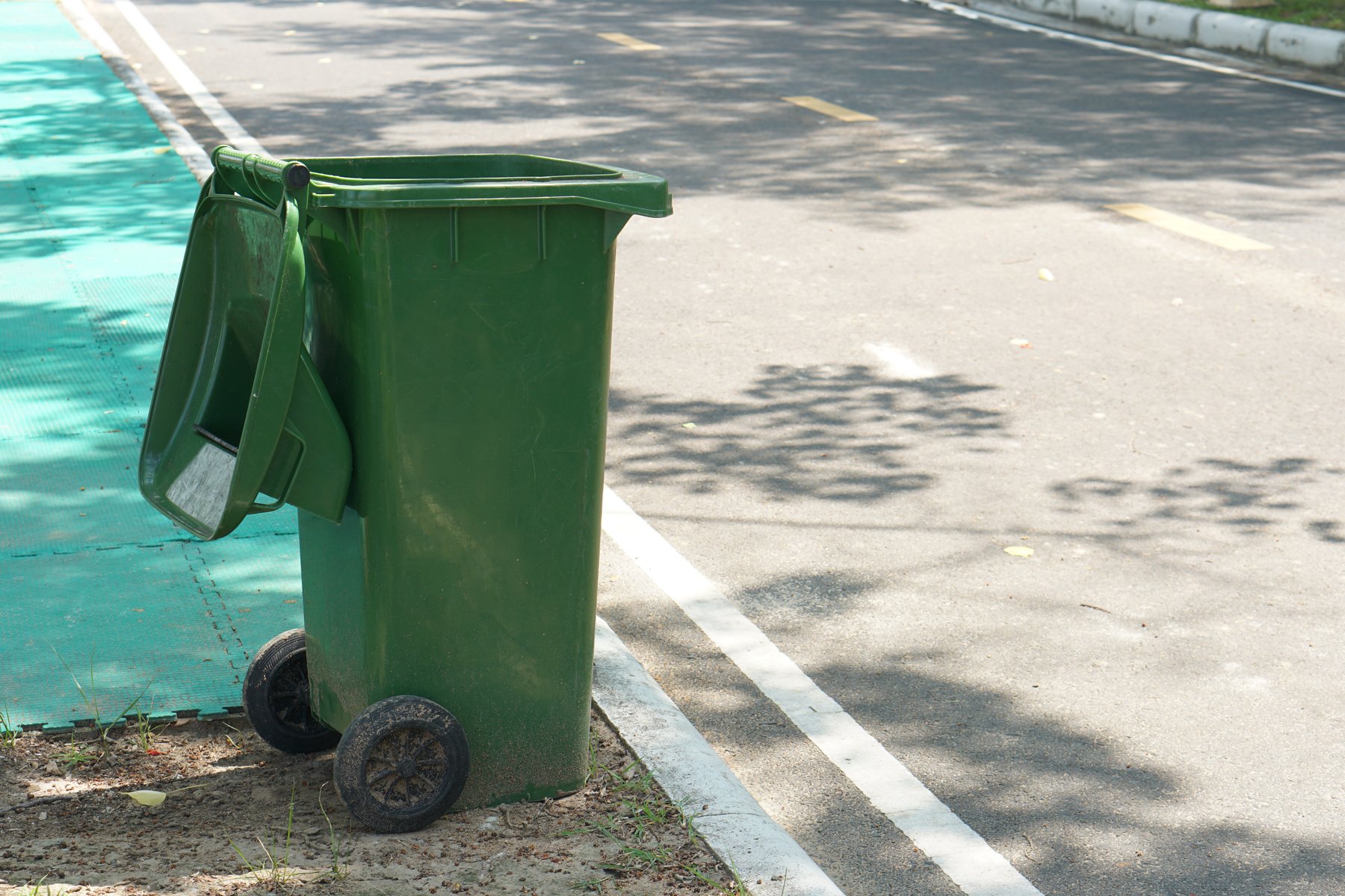 Green trash can in the park